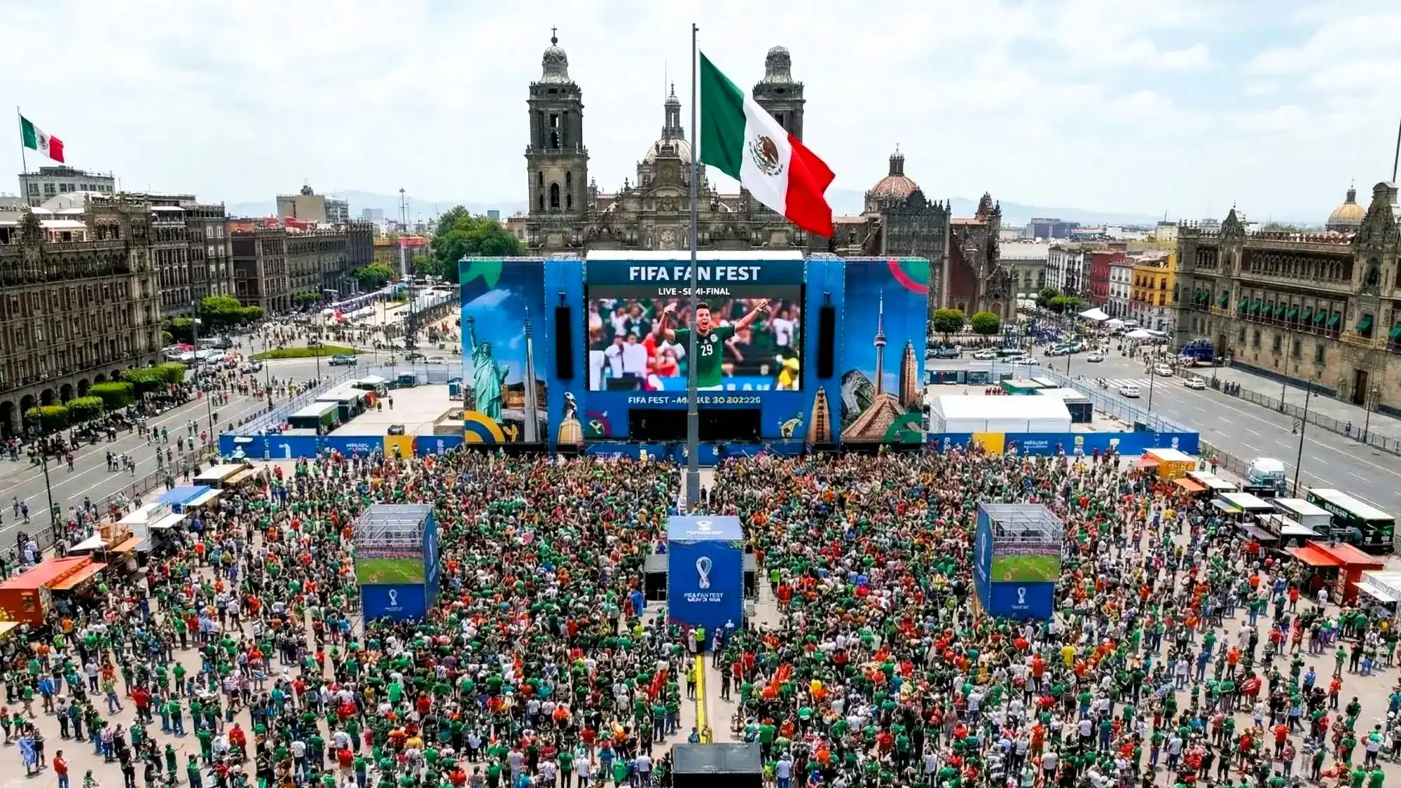Outdoor football fan festival watch party with supporters and large screens
