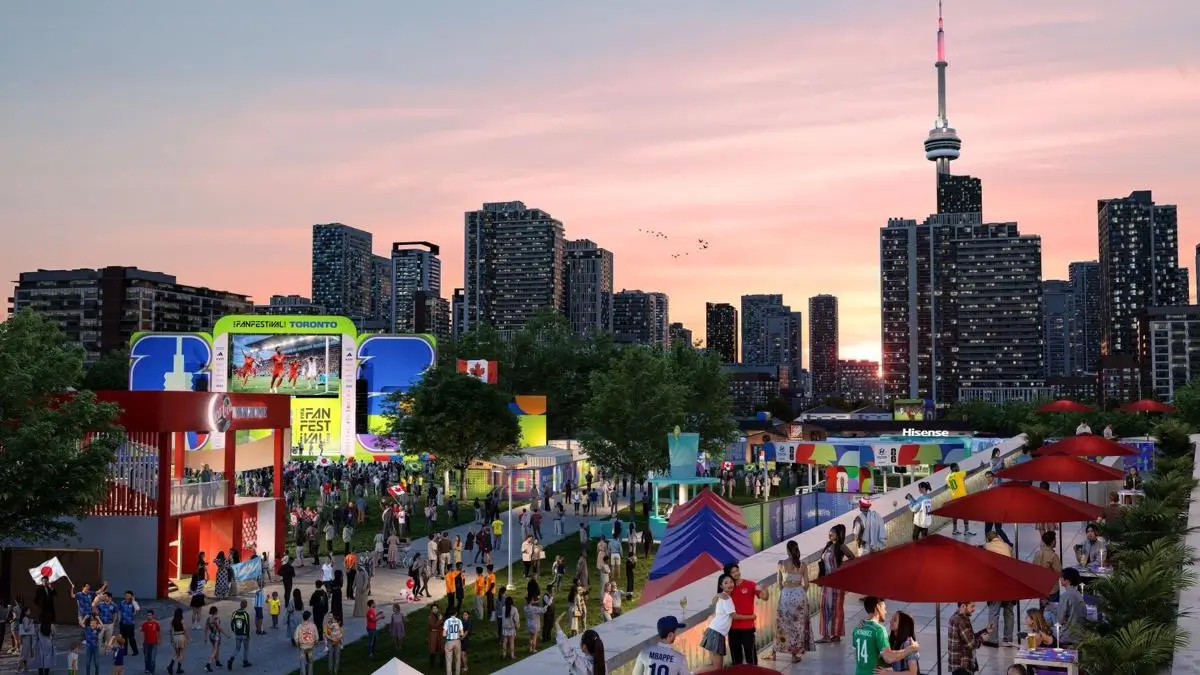Outdoor football fan festival watch party with supporters and large screens